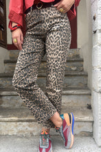 Load image into Gallery viewer, Person wearing leopard print pants and colorful sneakers on a staircase.